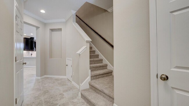 Main entrance view with entry from the garage door, superior quality clean carpet, all bedroom upsta - 1074 Amber Leaf Trail