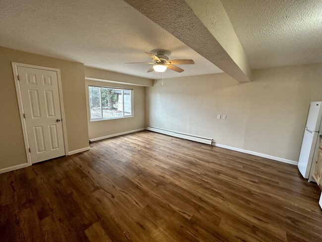 Experience modern comfort in this spacious living area with elegant flooring and ample natural light. - The Kimberly Apartments