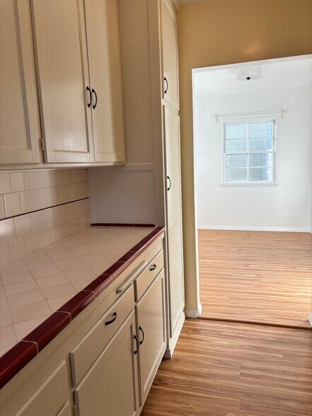 Looking from the kitchen to the light filled dining area. - 936 Palms Blvd