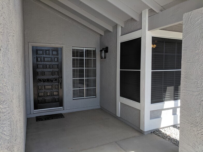Front Entry, photo cell light dusk to dawn. Front door stained to match cabinets. - 14101 N 78th Dr