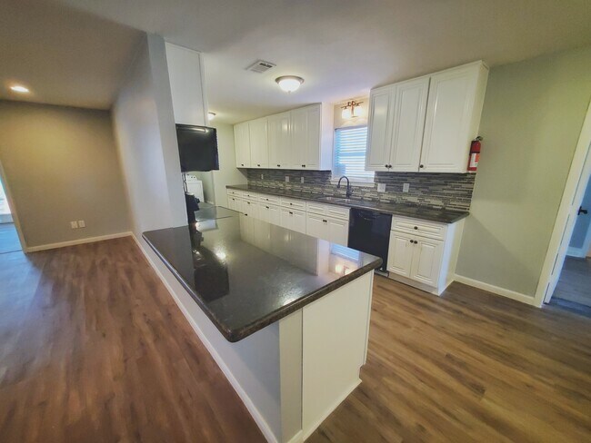 Huge galley kitchen opens to the living area with a beautiful peninsula with room for seating. - 37438 Meadowview Dr