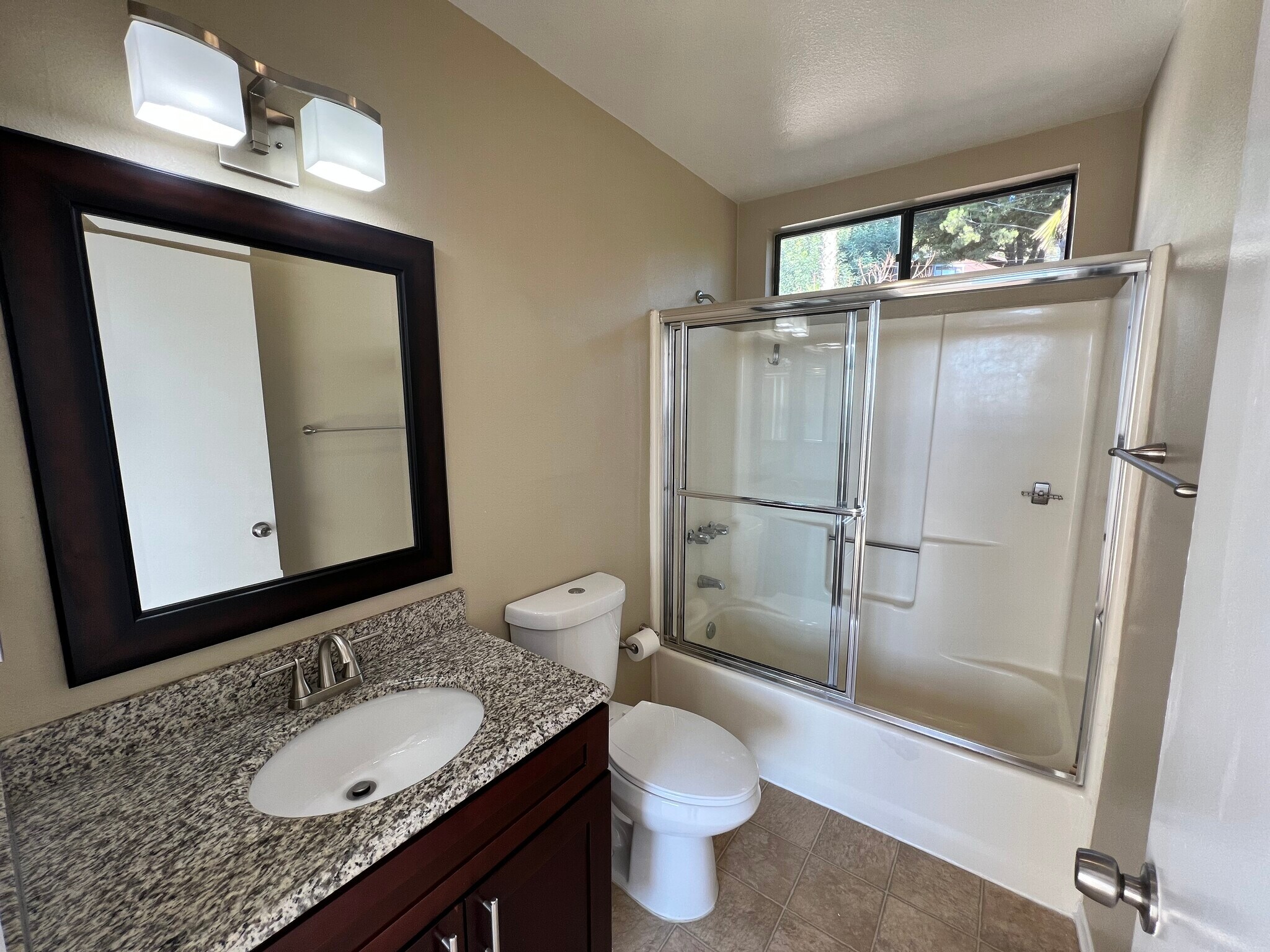 Primary suite attached bathroom with granite countertops - 3161 Weldon Ave
