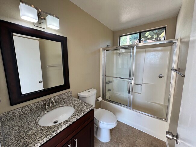 Primary suite attached bathroom with granite countertops - 3161 Weldon Ave