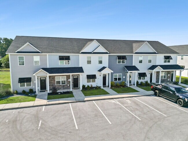 Building Photo - Available Now! Enjoy low-maintenance coastal living in this beautiful 2-bedroom, 2.5-bath townhom...