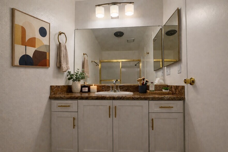 Updated bathroom with new shaker cabinetry, granite countertop, and brass hardware throughout - 970 Palm Avenue