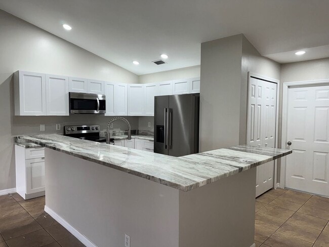 Building Photo - Experience this Cape Coral 3 bedroom 2 bath corner duplex with 1 car garage and screened in lanai.