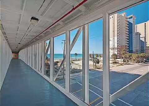 Covered skywalk connecting Ocean Villa with additional parking across the street. (Parking also ava - 10625 Front Beach Rd