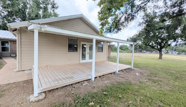 Large covered back porch is perfect for relaxing. - 37438 Meadowview Dr