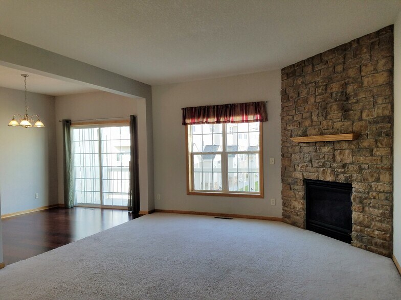 Living room fireplace and doors to balcony - 2407 Foxglove Cir