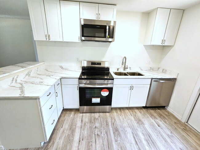 Building Photo - fully renovated 2-bedroom, 1-bathroom home with bonus guest room or office and oversized fenced yard