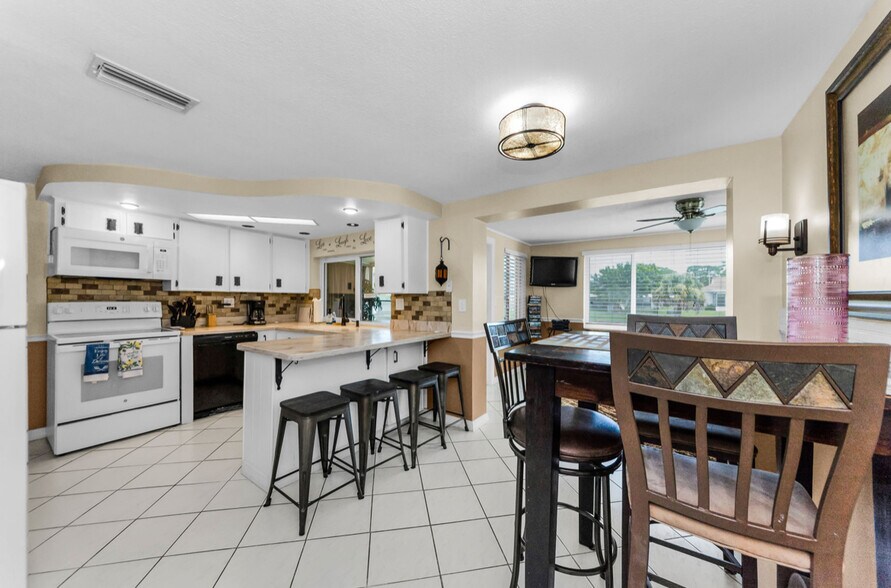 4 seating dinning table plus 4 on the kitchen counter. 4 more in Florida room. - 3931 Sail Dr