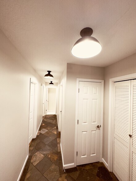 Laundry closet, linen closet, and view of hallway - 8717 NE Webster St