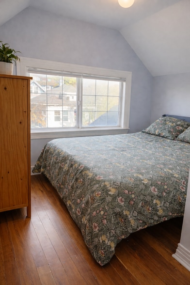 Upstairs bedroom 2: A peaceful, light-filled bedroom made for good sleep and slow mornings. - 604 NE Shaver St