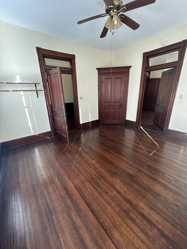 Coner bedroom with door to the right going to the middle bedroom and open door going to center hall. - 1118 25th St