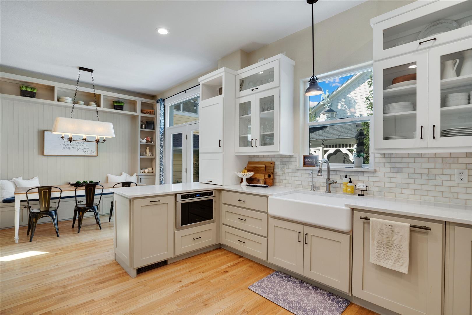 Slide-out microwave, bar seating, glass cabinets, and apron sink overlooking the courtyard - 4144 Lost Canyon Drive