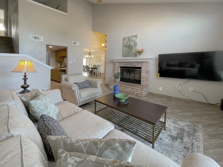 Living room with 65” smart TV - 5462 Gold Rush Dr NW