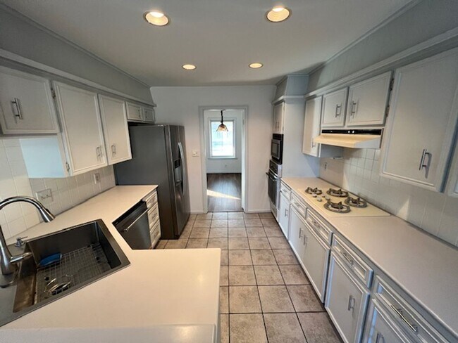 Building Photo - Step into this inviting, sunlit home where space and comfort blend seamlessly