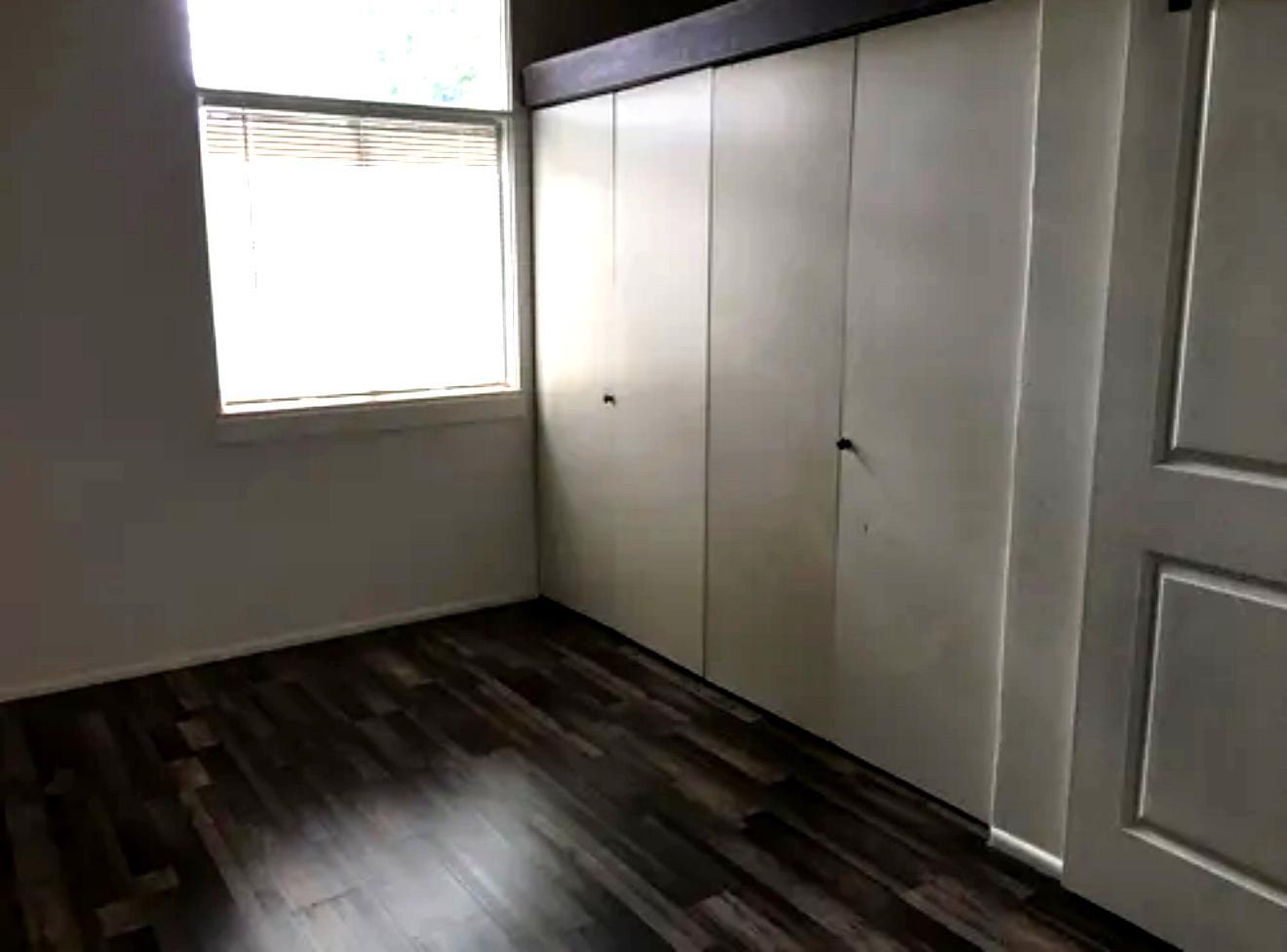 View of Second Bedroom Large Closet with storage loft above. Window viewing front yard - 506 122nd St S