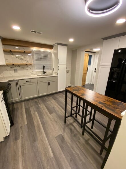 Modern kitchen with bar seating area - 1603 Washington St E