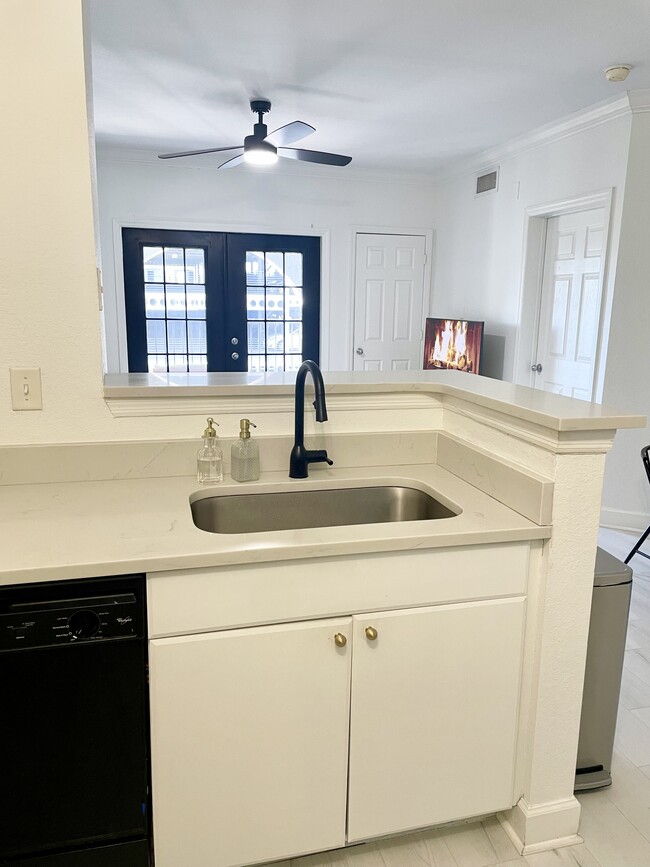Black modern Moen faucet, single stainless steel sink, and new garbage disposal - 304 E South St