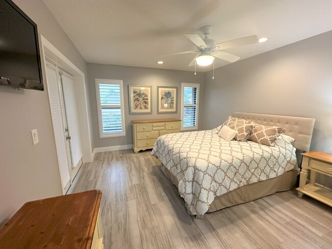 Main Bedroom- French Doors, TV - 7723 SE Sugar Sand Cir