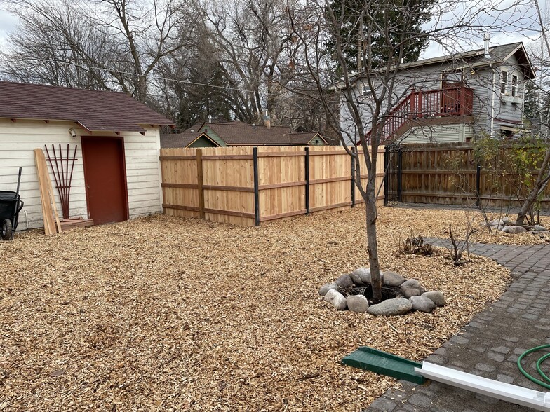 backyard in spring - freestanding garage, mature roses, cherry tree, and paver patio - 508 Daly Ave