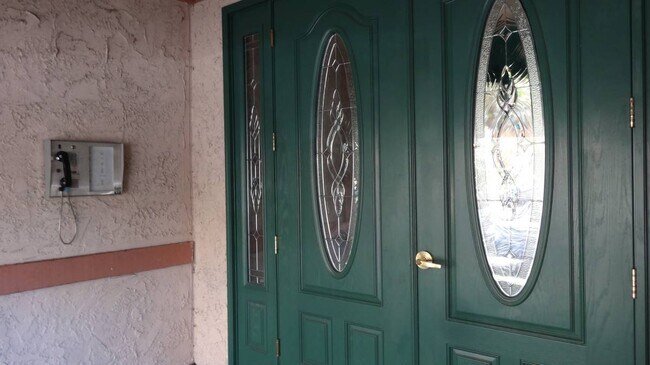 Doors to the condo complex with securityu - 12030 Rochester Ave