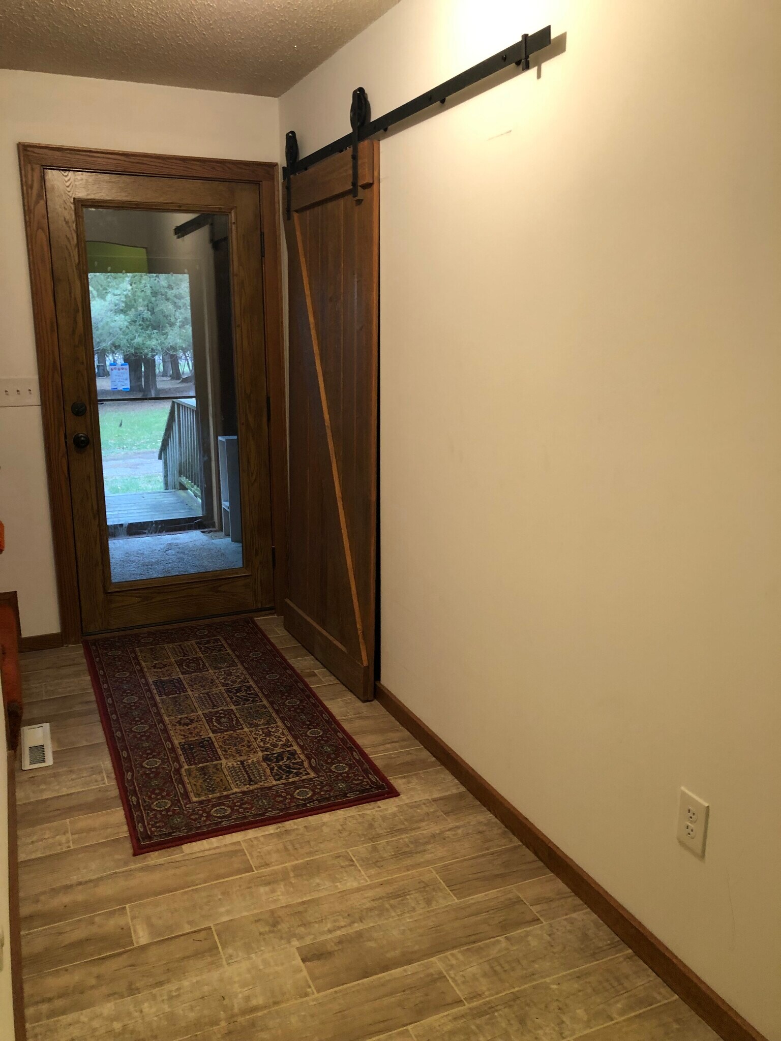 Entryway to 3 Season Porch and closet with Barn door - 23260 Bridgestone Rd NW