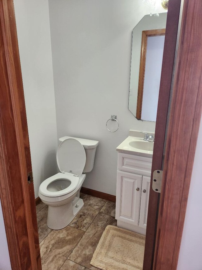 Half Bath with new flooring, toilet, vanity and sink. - 6568 Ward Rd