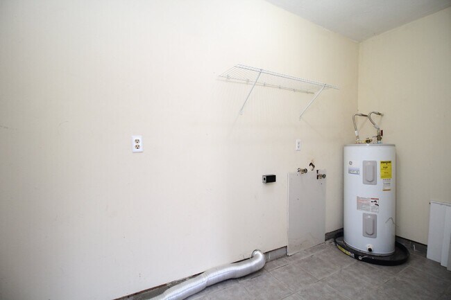 Building Photo - Spacious 3BR/1.5BA Home in Pace with Open Living Area, Tiled Family Room, and Fenced Backyard – M...