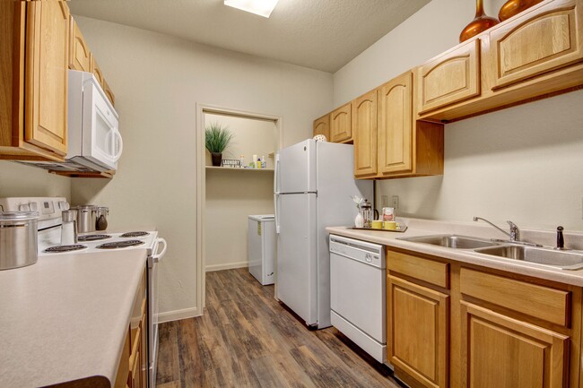 An open kitchen with lots of cabinet storage and easy access to the laundry room - The Residence at Heritage Park