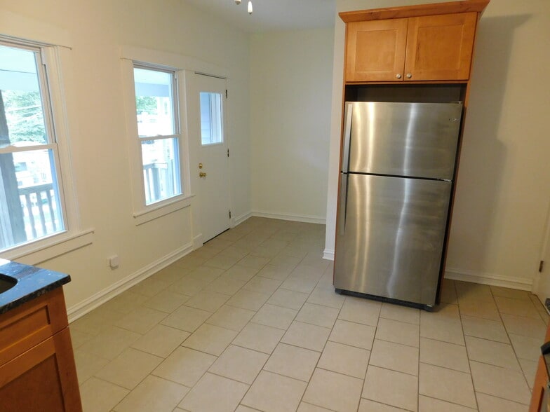 Kitchen has area for table and access to the porch. - 1566 Dewey Ave