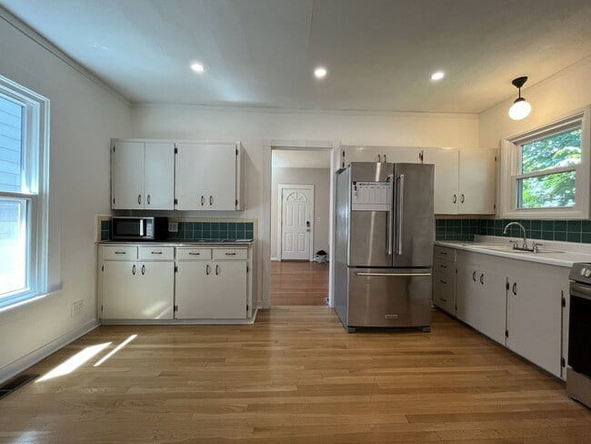 Building Photo - Charming Cottage with Hardwood Flooring, Modern Kitchen & Beautiful Outdoor Living Areas