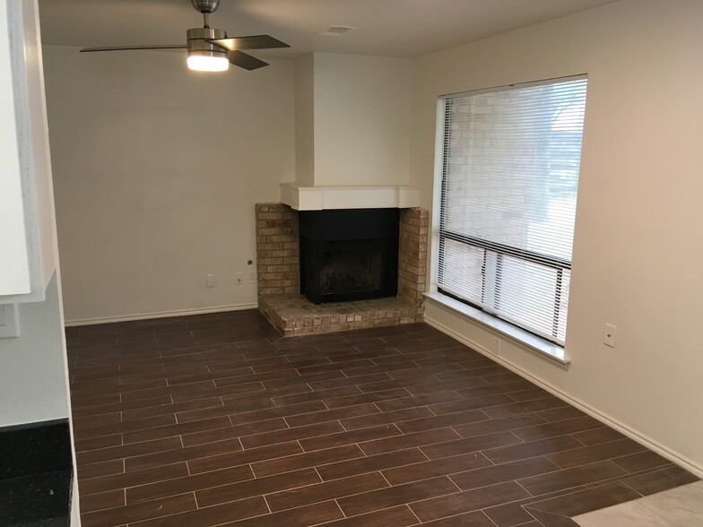 Sunny living area with fireplace. - 8604 Willowick Drive