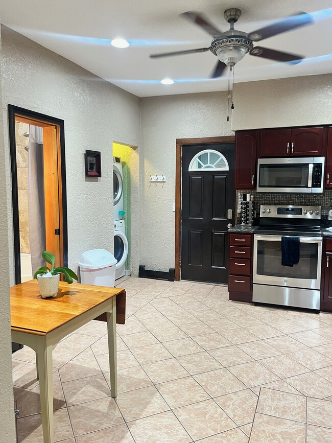 Kitchen, with backdoor, in unit FREE laundry, and doorway into the bathroom - 3517 19th Ave S