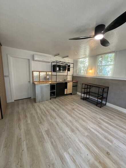 Open layout with sleek kitchenette + dining area—perfect for a simple, uncluttered setup. - 24606 University Ave