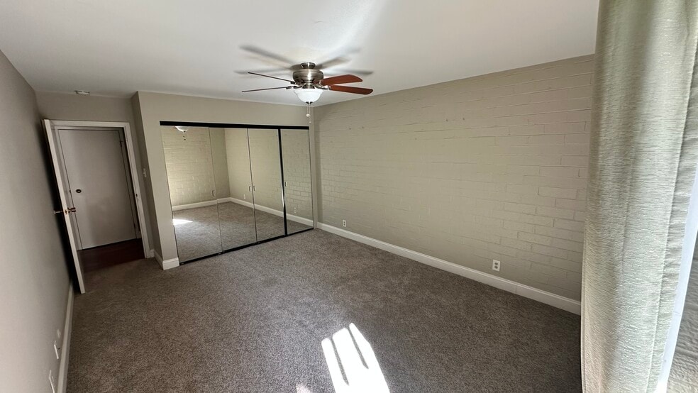 Carpeted bedroom with mirrored closet - 460 S Marion Pky