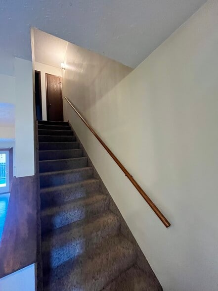 stairs to bedrooms and full bath - 4414 Solar Pl