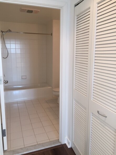 Hallway to the bathroom. Washer and Dryer station behind the door to the right. - 250 King St