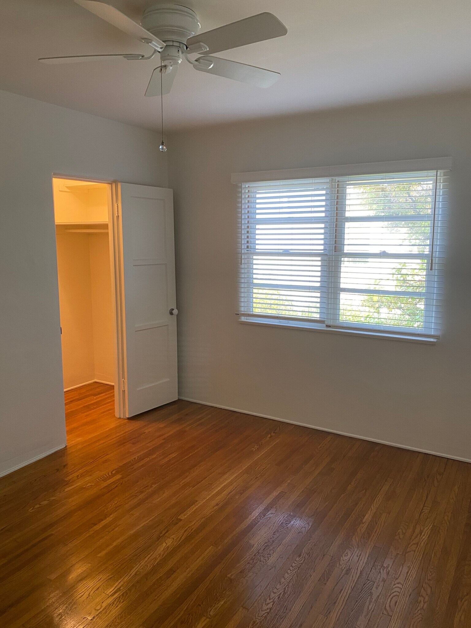 Bedroom with walk in closet and ceiling fan - 449 San Vicente Blvd