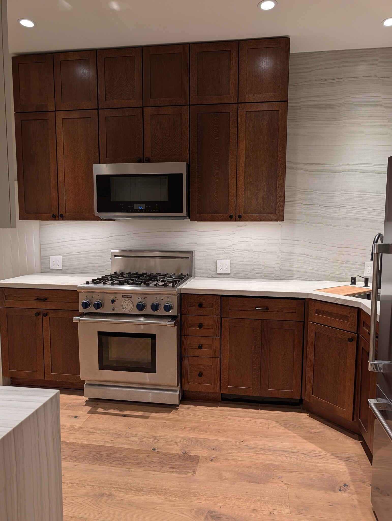 The kitchen. Floor-to-ceiling cabinets, expansive natural stone counters, chef appliances. - 328 Lexington St