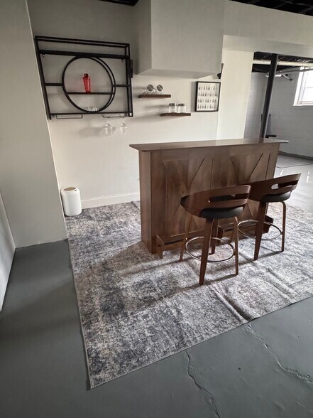 A stylish basement bar area perfect for mixing drinks, hosting, or enjoying a night in. - 2394 Bouldercliff Way SE