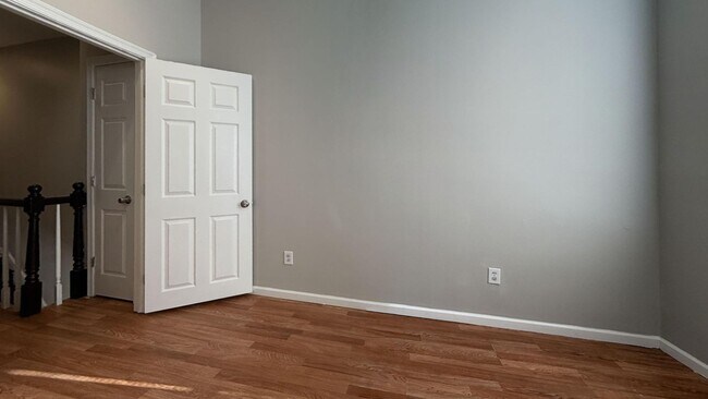 Building Photo - Charming 4BR/2BA Rowhouse with Hardwood-Style Flooring Throughout