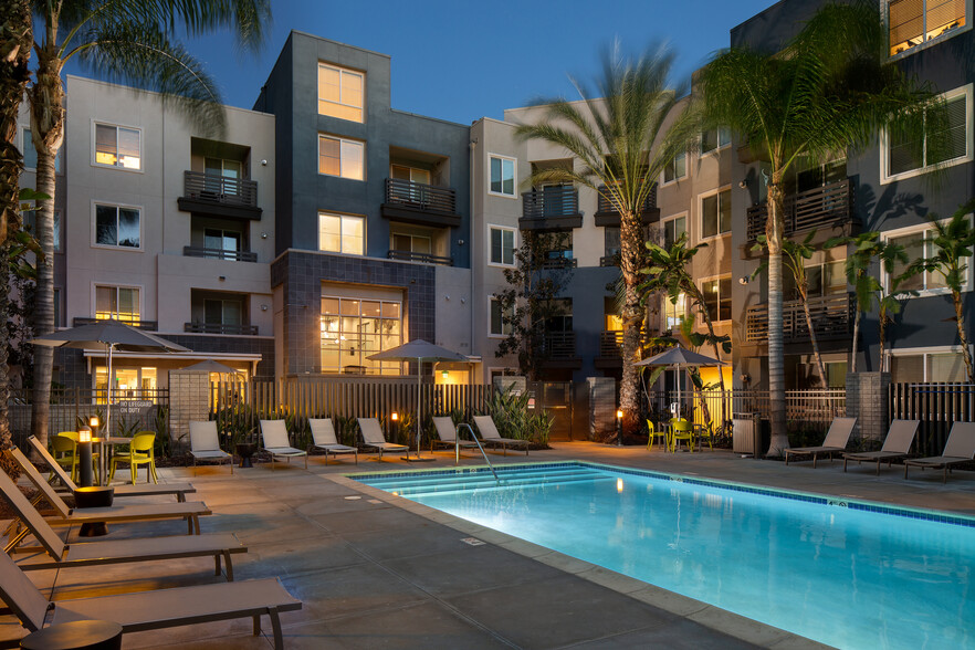 Swimming pool and sundeck at dusk - Avalon Warner Place