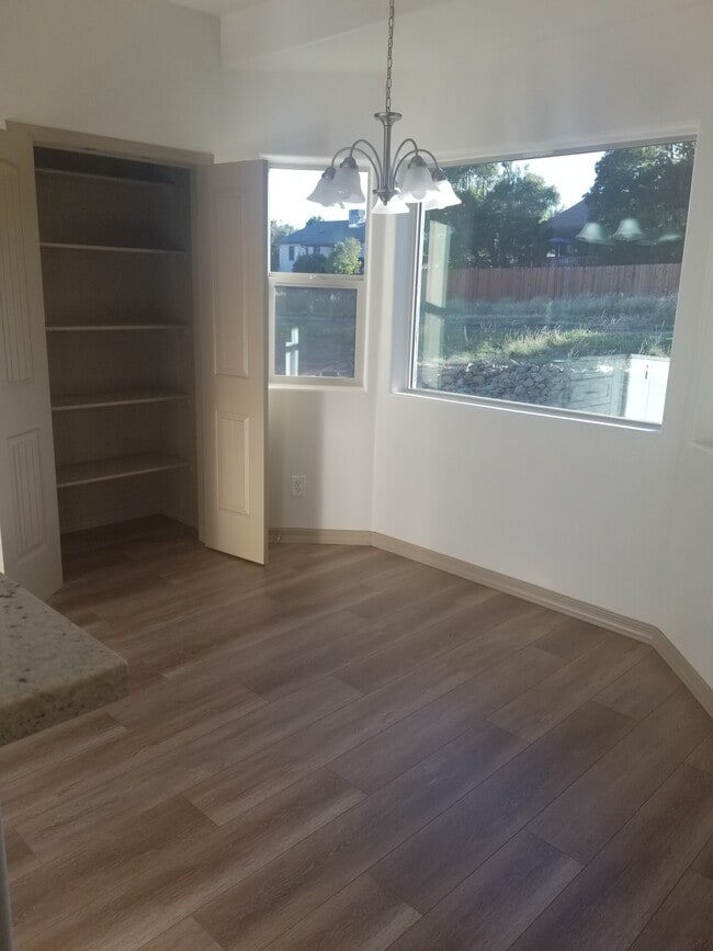 Eat in dining room with spacious bay window overlooking the backyard and large kitchen pantry. - 5180 N Roadrunner Dr