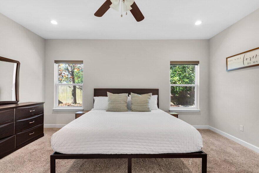 Master bedroom with cozy memory foam king bed, fresh linens, dressers, nightstands, and TV - 28 Snook Rd