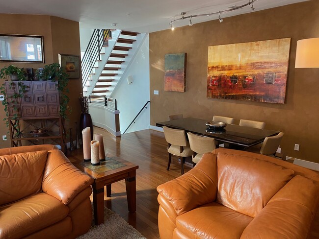 View of dining table - stairs to bedrooms and front door in background - 1714 W Cary St