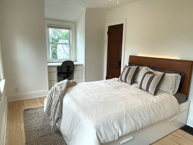 Primary bedroom with with built in desk and ceiling fan. - 3209 Atwood Ave