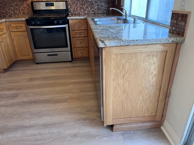 View of new granite countertops, stainless steel appliances and cabinets in kitchen - 2356 Canyon Park Dr