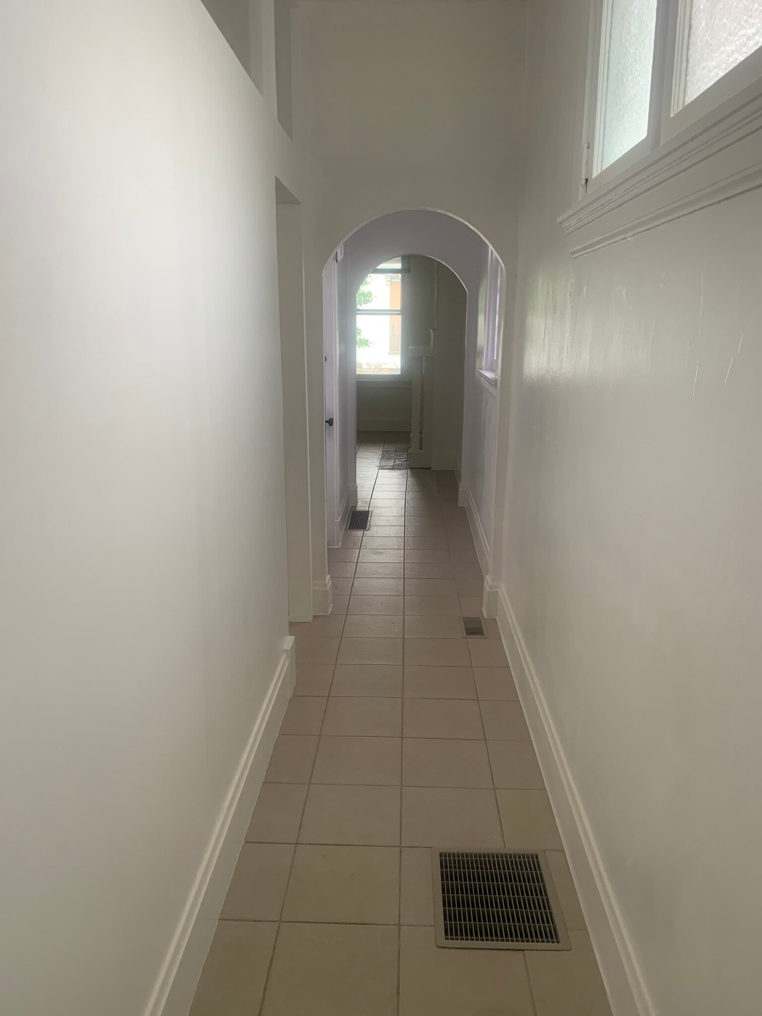 Hallway looking back at living room with first bedroom door on left - 911 Putnam St